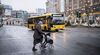 A woman with a protective face mask and a rollator crosses the street in front of KaDeWe Shopping store during Germany's second lockdown amid the ongoing novel coronavirus / COVID-19 pandemic in Berlin on December 23, 2020. (Photo by STEFANIE LOOS / AFP) (Photo by STEFANIE LOOS/AFP via Getty Images)