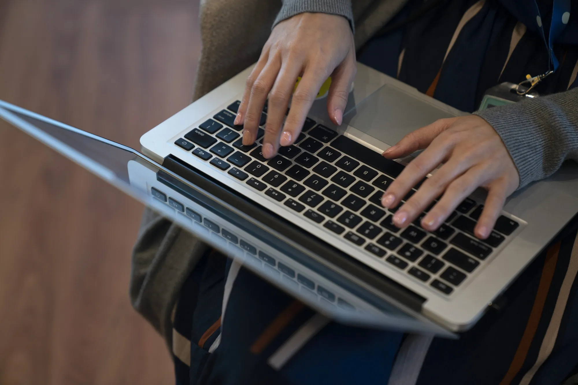 A person works on a laptop computer.