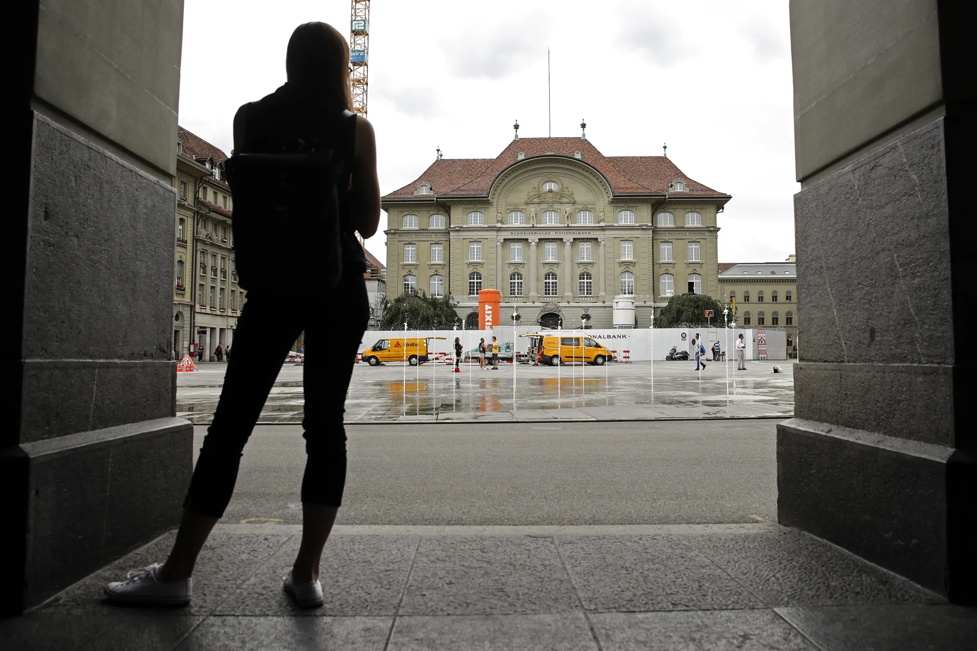 A pedestrian looks towards the Swiss National Bank (SNB) building in Bern.