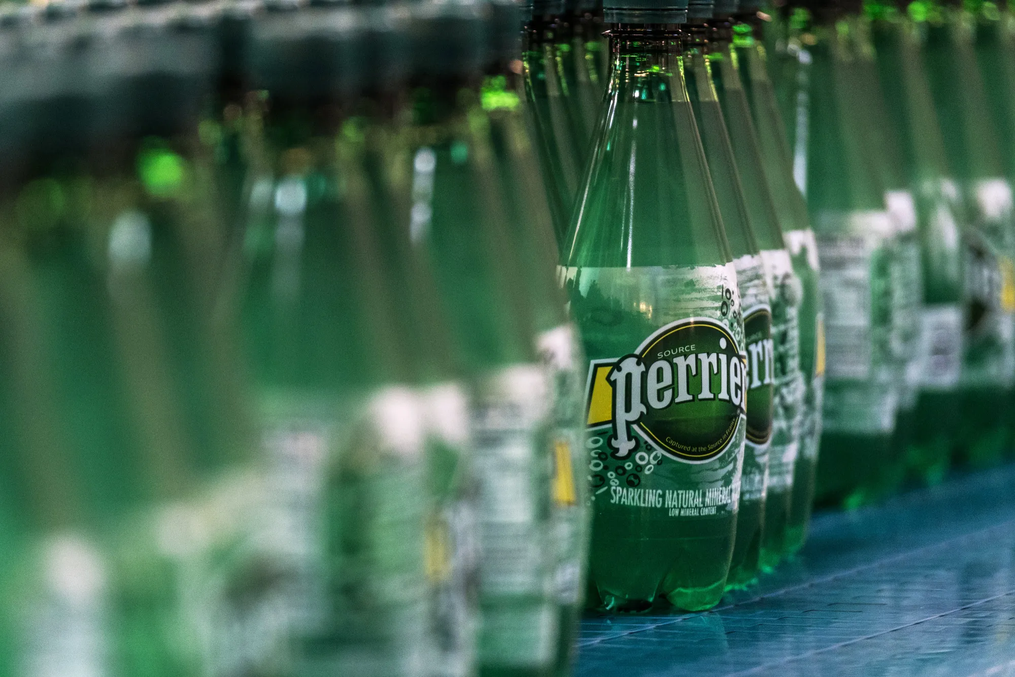 Bottles of Perrier mineral water on the production line at the Nestle SA bottling plant in Vergeze.