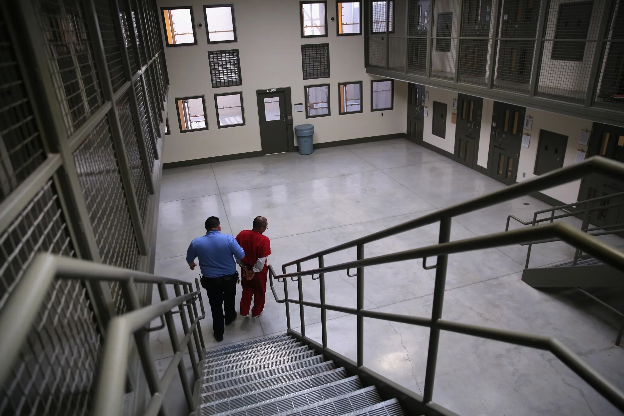 A guard escorts an immigrant detainee at the Adelanto Detention Facility in Adelanto, California.