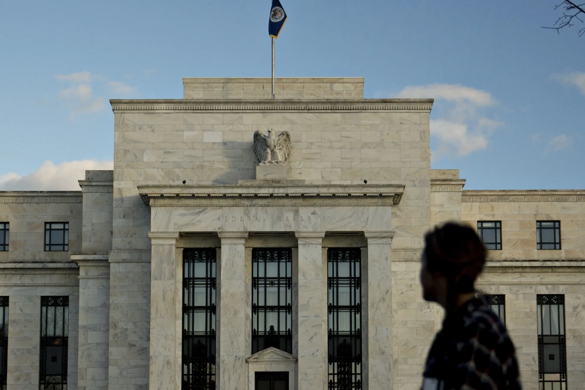 A pedestrian walks past the Marriner S. Eccles Federal Reserve building in Washington.