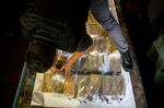 A member of a military transportation agency unloads gold bars from a plane for transport to the Central Bank of Venezuela.