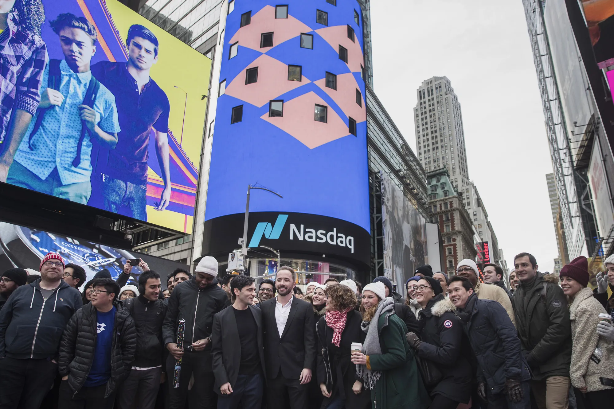 Drew Houston, chief executive officer and co-founder of Dropbox Inc., center right, and Arash Ferdowsi, co-founder of Dropbox Inc., center left, stand for a photograph&nbsp;outside the Nasdaq MarketSite during the company's IPO&nbsp;in New York.