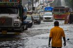 Vehicles drive through a waterlogged road after a heavy monsoon rainfall in Mumbai.