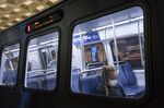 A commuter wears a protective face mask while riding on a subway train in Washington, D.C., U.S., on Monday, March 16, 2020.&nbsp;