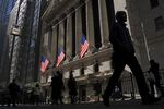 People walk past the New York Stock Exchange.
