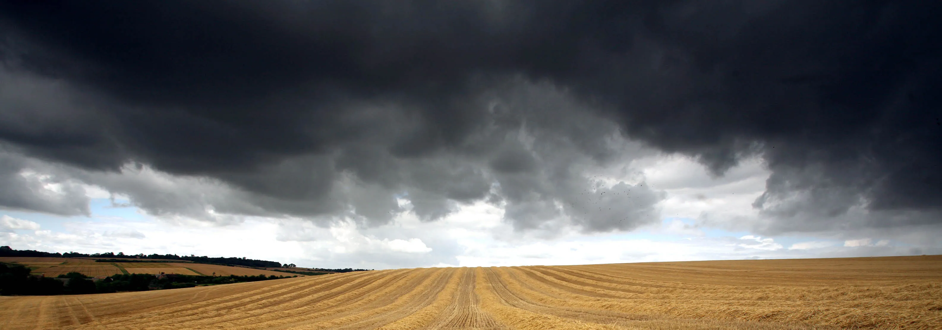 Storm clouds gather over a recently harvested hay field in Ickleton, Cambridgeshire, Wednesday, July 18, 2007.