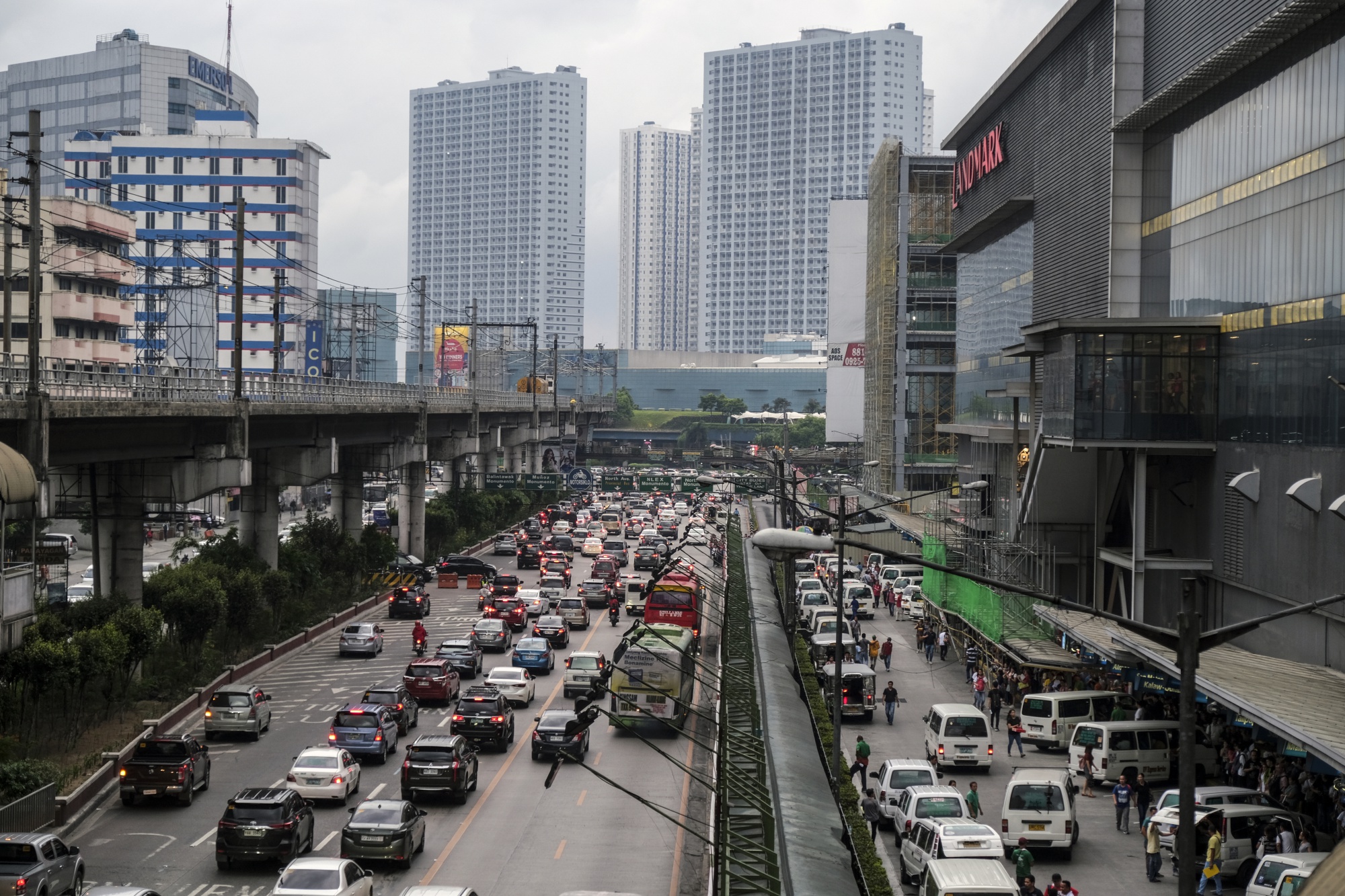 Vehicles travel along a road during rush hour in Manila.