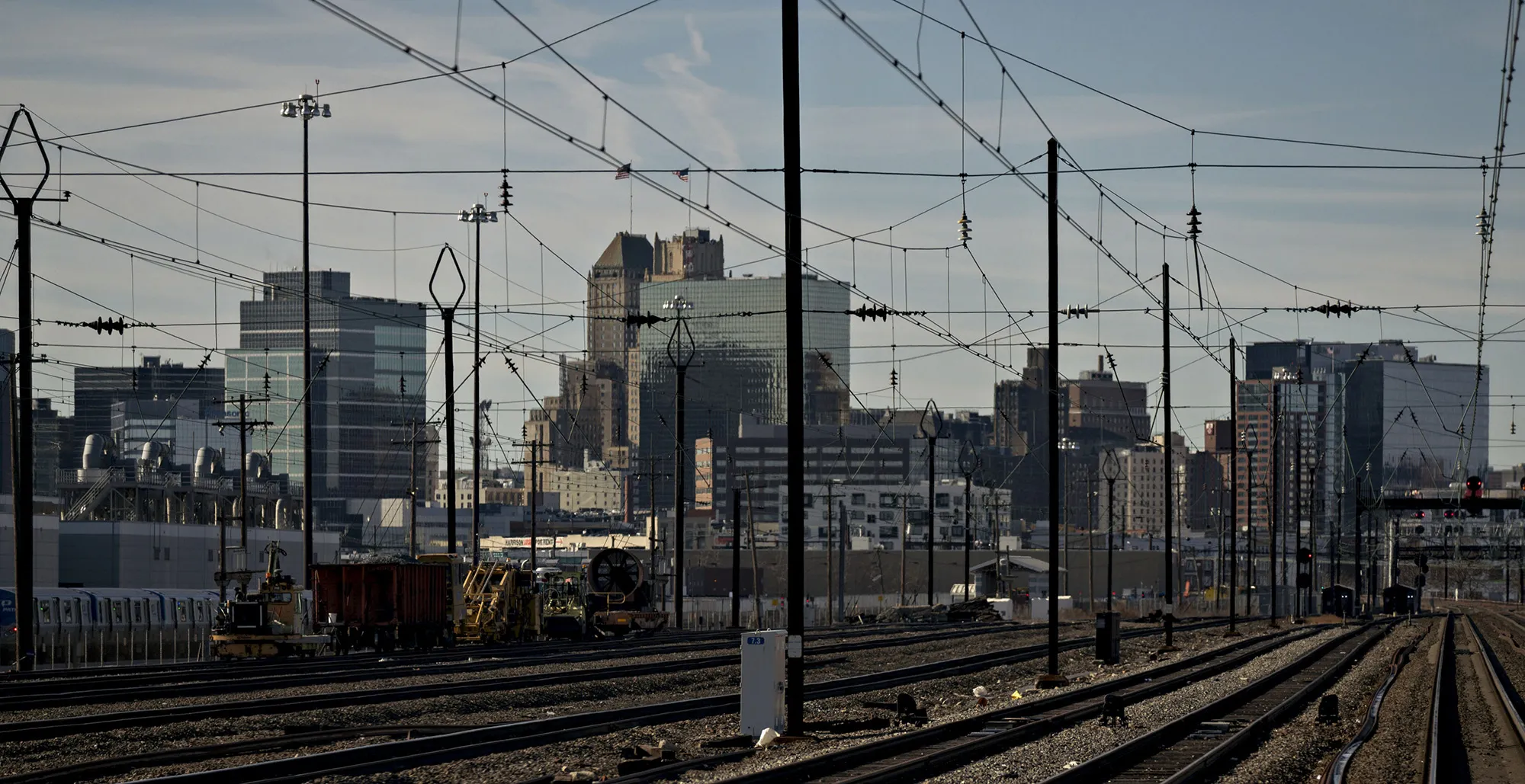 Buildings&nbsp;stand&nbsp;past catenary wire and train tracks&nbsp;in Newark, New Jersey.