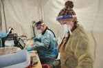 Healthcare workers prepare Covid-19 tests at a Nomi Health testing site in Omaha, Nebraska, U.S., on Wednesday, Nov. 10, 2021.  