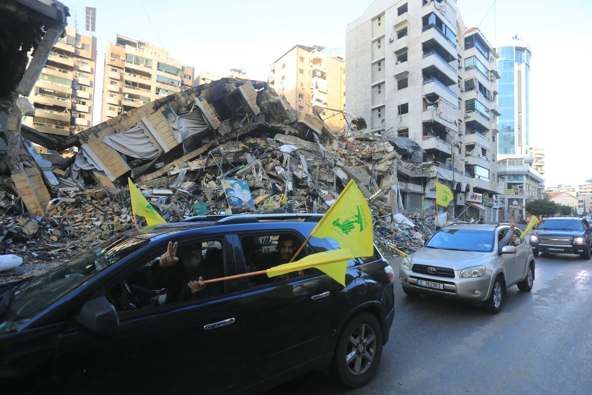 Motorists wave Hezbollah flags as they parade in Beirut's southern suburbs on Nov. 27.