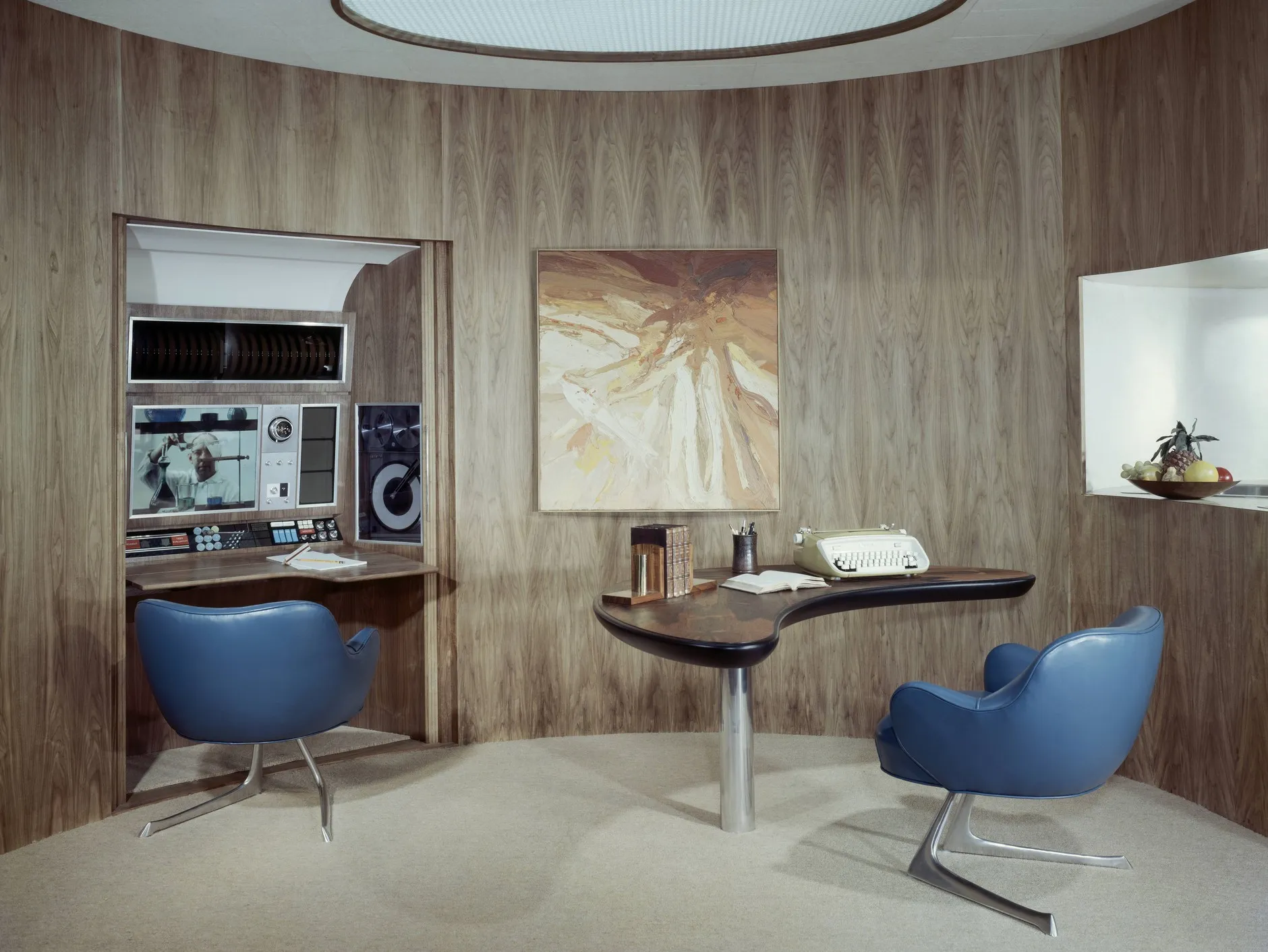 
A space-age home office of 1963 boasts a stereo alcove and swoopy aluminum-and-rosewood desk.
