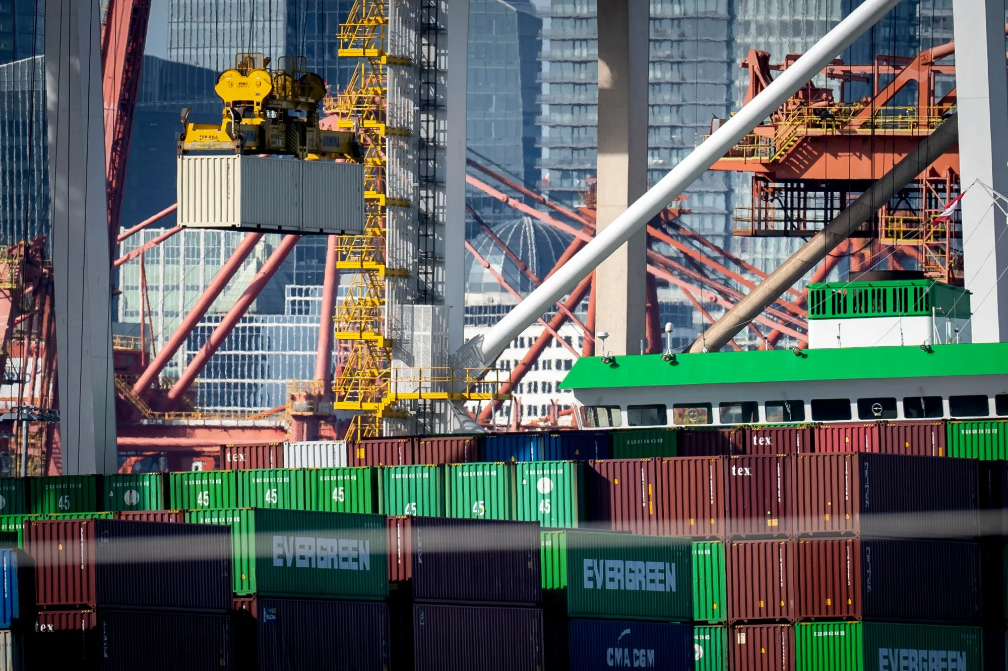 Container cranes unload a ship at the Port of Vancouver.