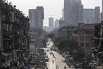 Pedestrians walk along the near-empty Mohammed Ali Road during a lockdown in Mumbai, on March 25.