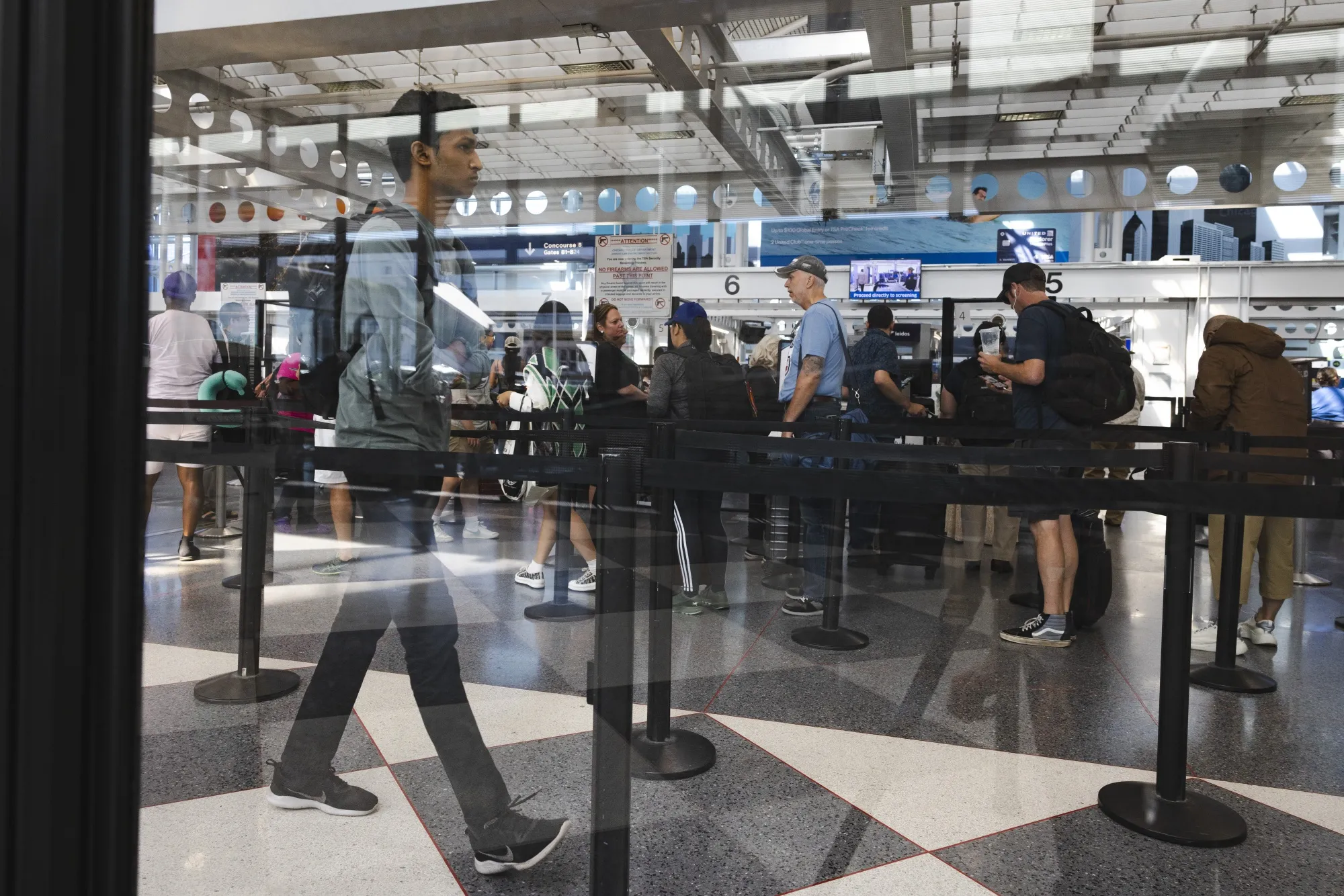 Travelers wait in line at the security checkpoint at O’Hare International Airport in Chicago, Illinois.