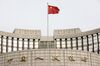 A Chinese flag flies in front of the People's Bank of China headquarters in Beijing, China, on Monday, Jan. 7, 2019. The central bank on Friday announced another cut to the amount of cash lenders must hold as reserves in a move to release a net 800 billion yuan ($117 billion) of liquidity and offset a funding squeeze ahead of the Chinese New Year.
