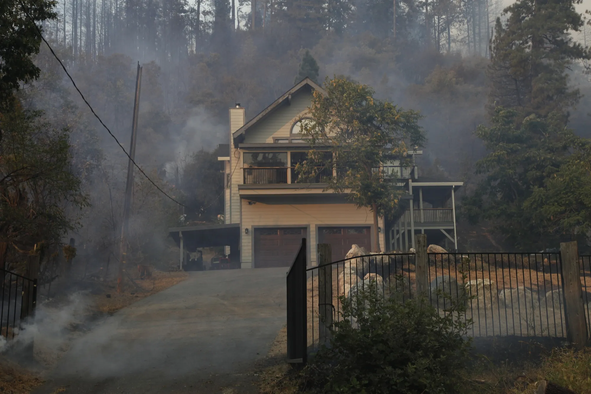 Smoke rises around a home during the Mosquito Fire near Michigan Bluff, California, US, Sept. 7, 2022.&nbsp;