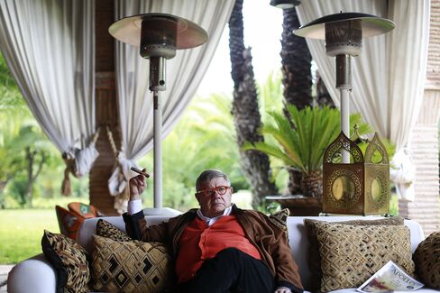 Jean-Yves Ollivier pauses while smoking a cigar during an interview at his Marrakesh house.