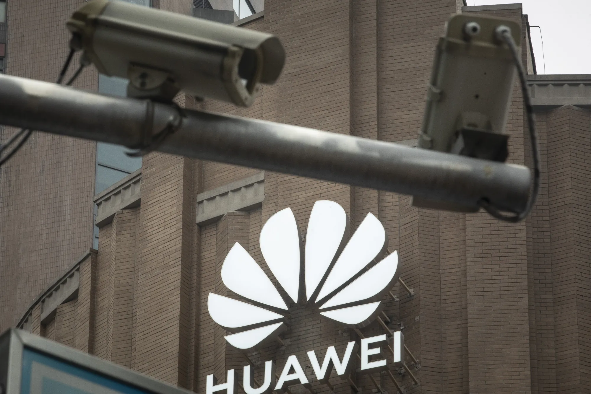 Public surveillance cameras are mounted to a pole in front of Huawei Technologies Co.'s flagship store in Shanghai, China.