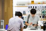 Customers try out the Samsung Electronics Co. Galaxy Note 8 smartphone at the company's D'light flagship store in Seoul, South Korea.