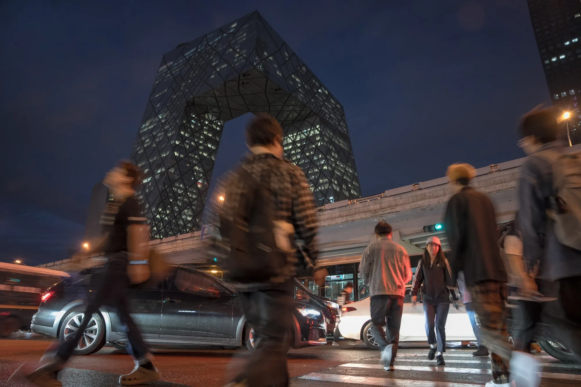 Pedestrians in Beijing at a crossroads, a bit like the economy, which is strained, a bit like this visual metaphor.
