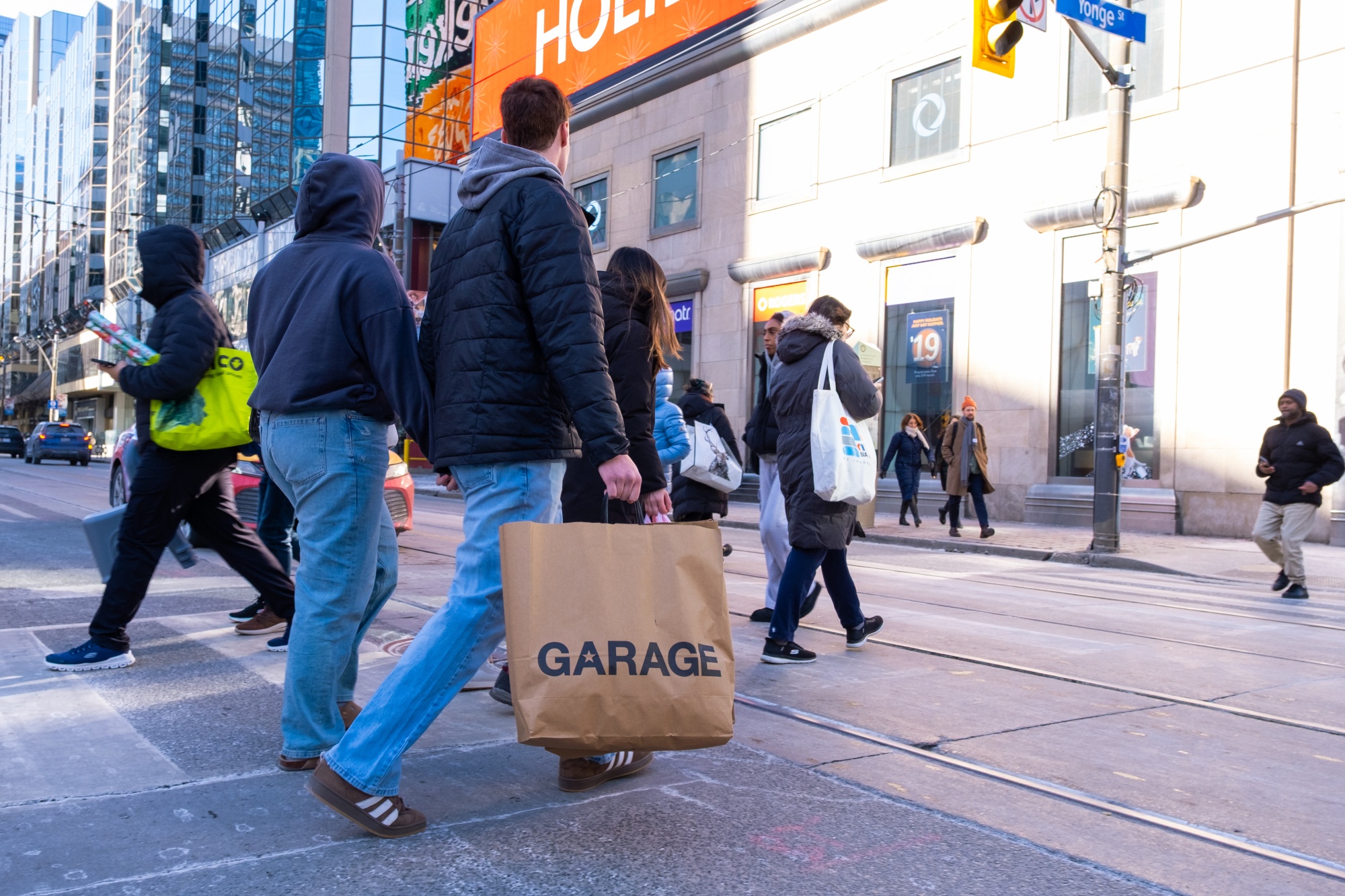 A shopper carries a Garage bag in Toronto, Ontario, Canada, on Monday, Dec. 8, 2025. Statistics Canada (STCA) is scheduled to release consumer price index data on November 15. Photographer: Adetona Omokanye/Bloomberg