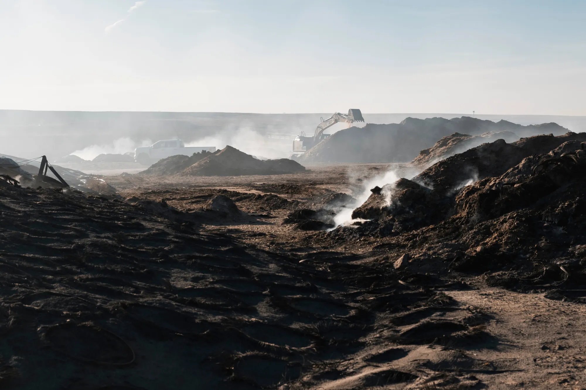 Smoke rises from a feed lot following the Smokehouse Creek Fire.