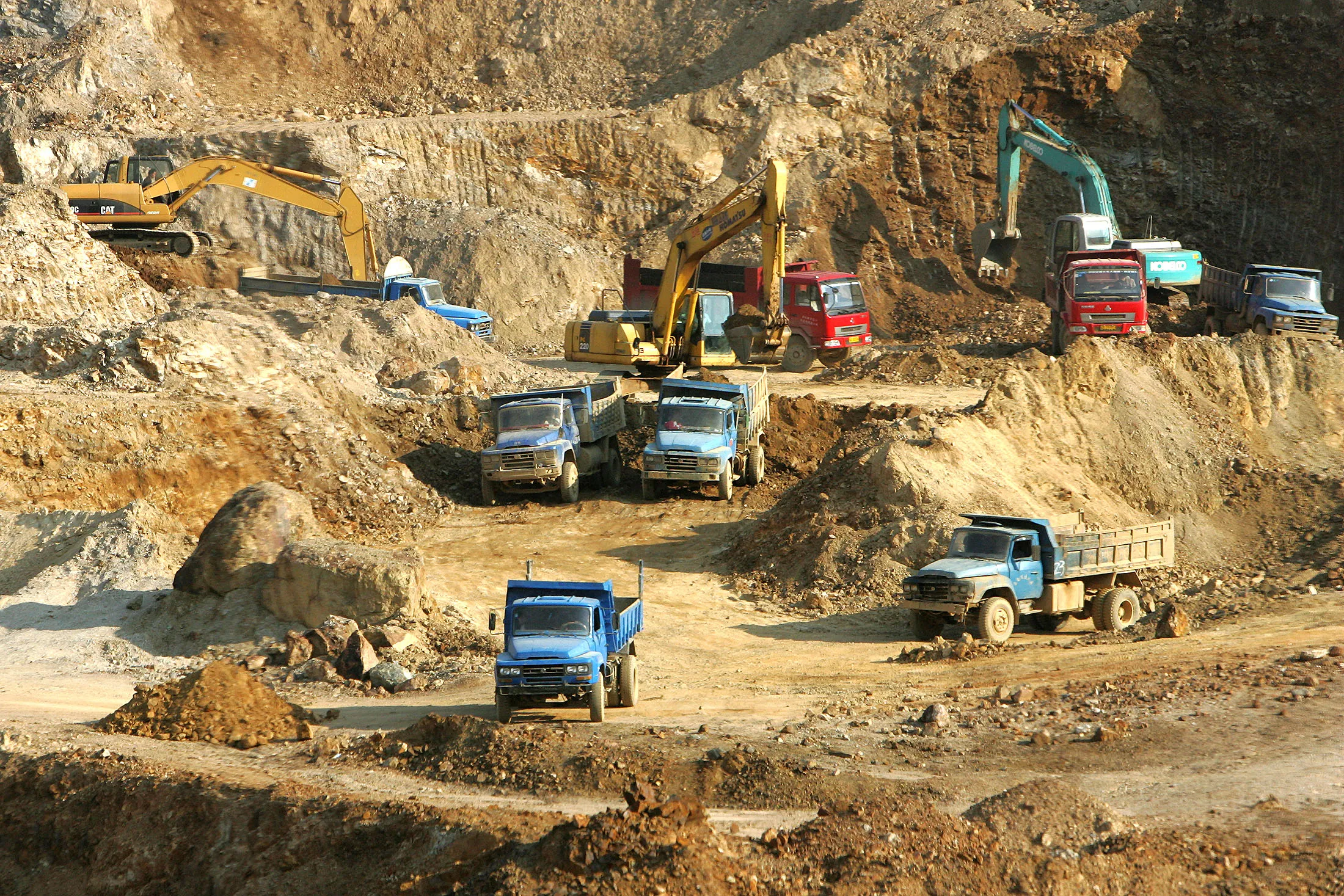 Excavators load trucks with rare earth at a mine in&nbsp;southwest China.
