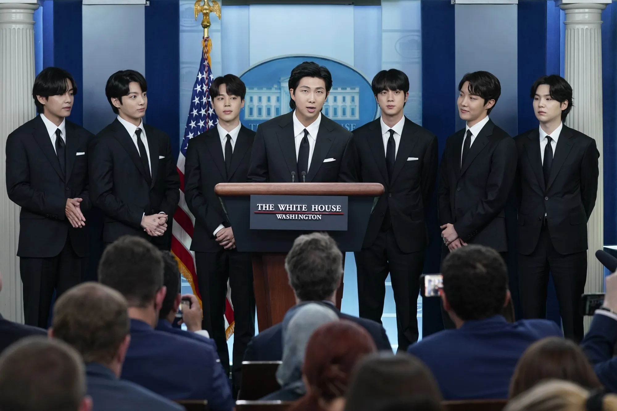 RM, center, accompanied by other K-pop supergroup BTS members from left, V, Jungkook, Jimin, Jin, J-Hope, and Suga speaks during the daily briefing at the White House in Washington, Tuesday, May 31, 2022. The members of K-pop band BTS will serve their mandatory military duties under South Korean law, their management company said Monday, Oct. 17, 2022, effectively ending a debate on exempting them because of their artistic accomplishments. (AP Photo/Evan Vucci, File)