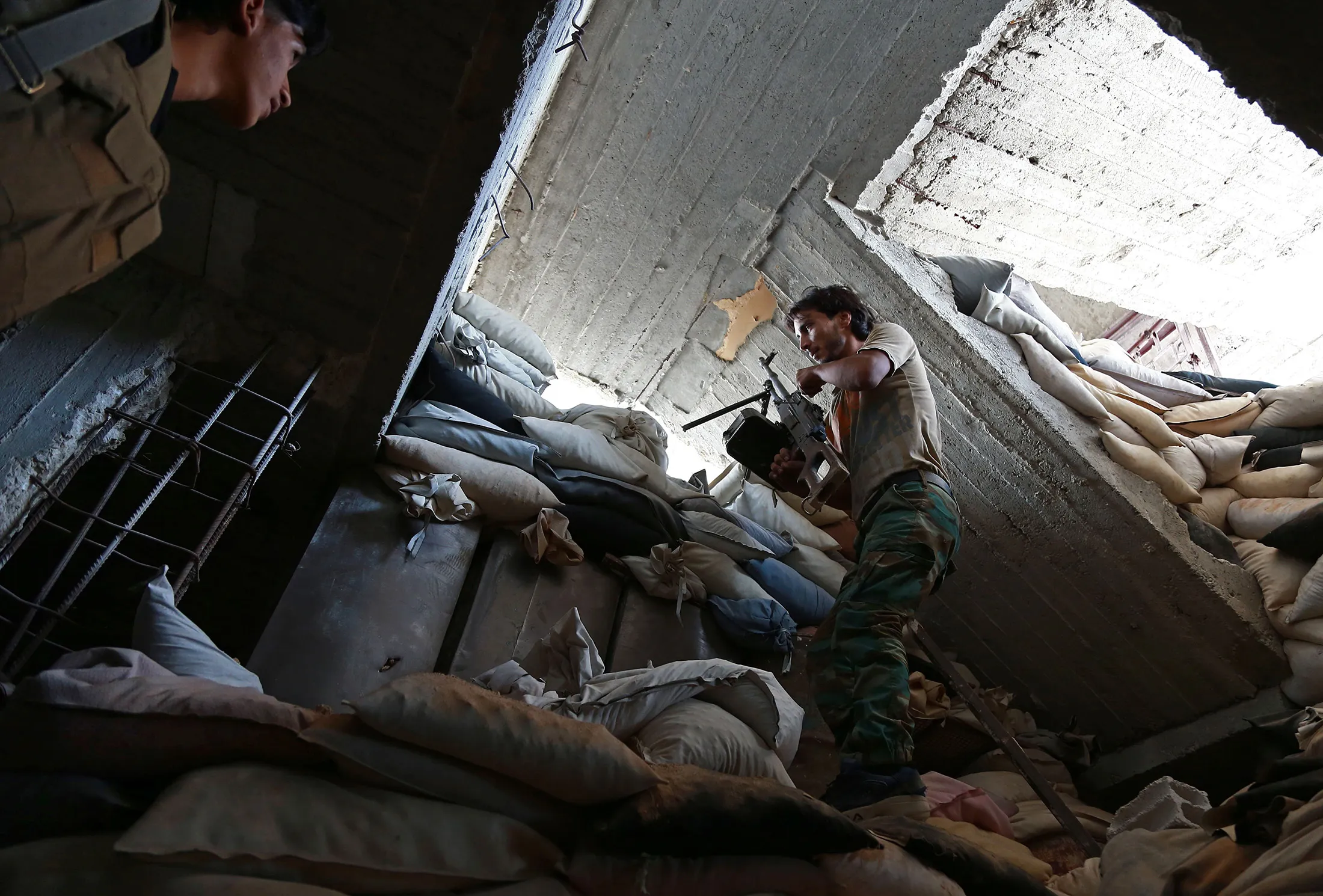 Fighters from the Islamist rebel faction al-Rahman Corps guard a look out point in Ain Tarma, Syria on Sept. 14, 2017.
