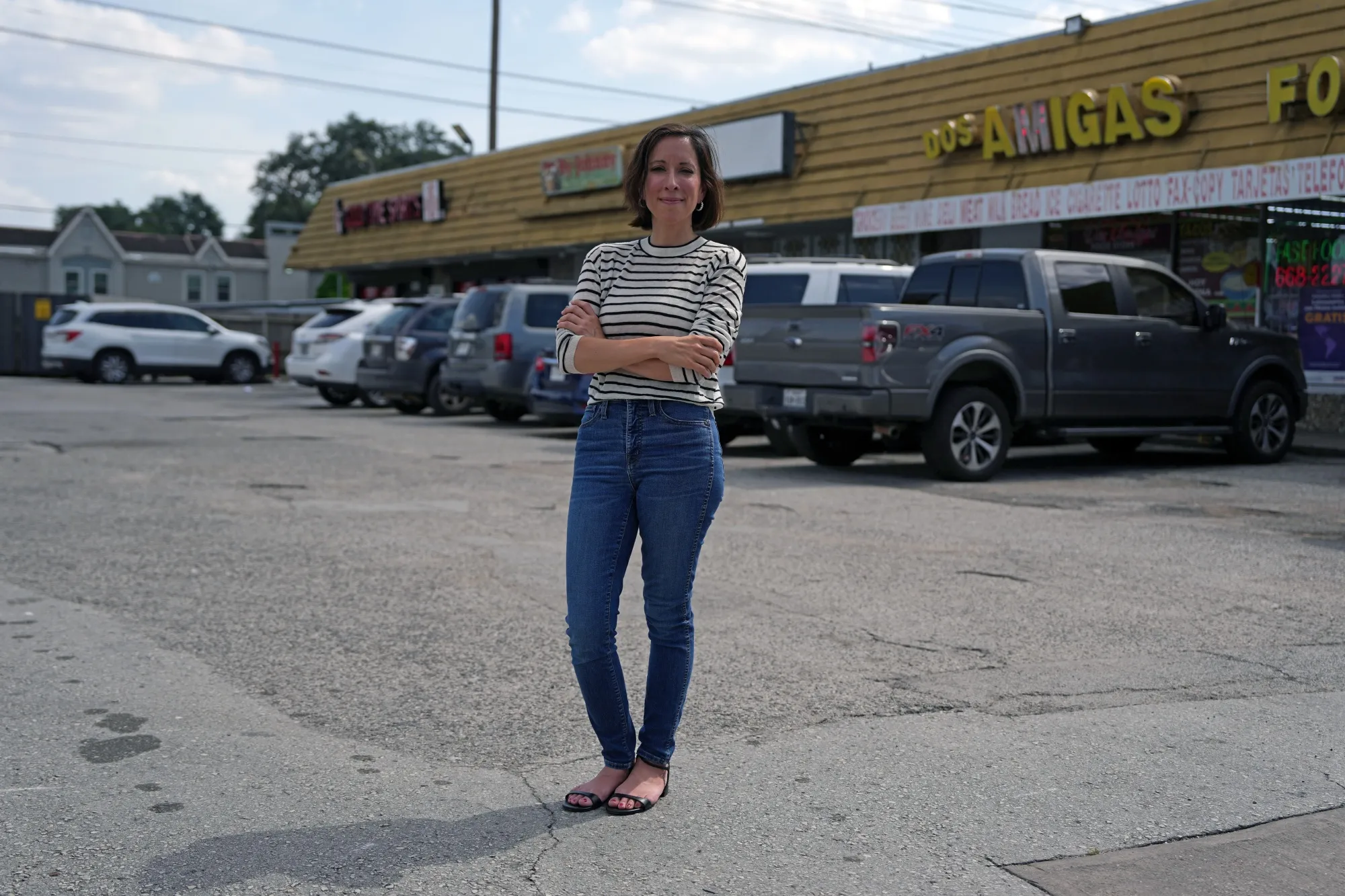 Sara Bronin, founder of the National Zoning Atlas, stands in front of a shopping plaza nestled between housing complexes in her native Houston —&nbsp;a city that lacks traditional zoning laws.&nbsp;
