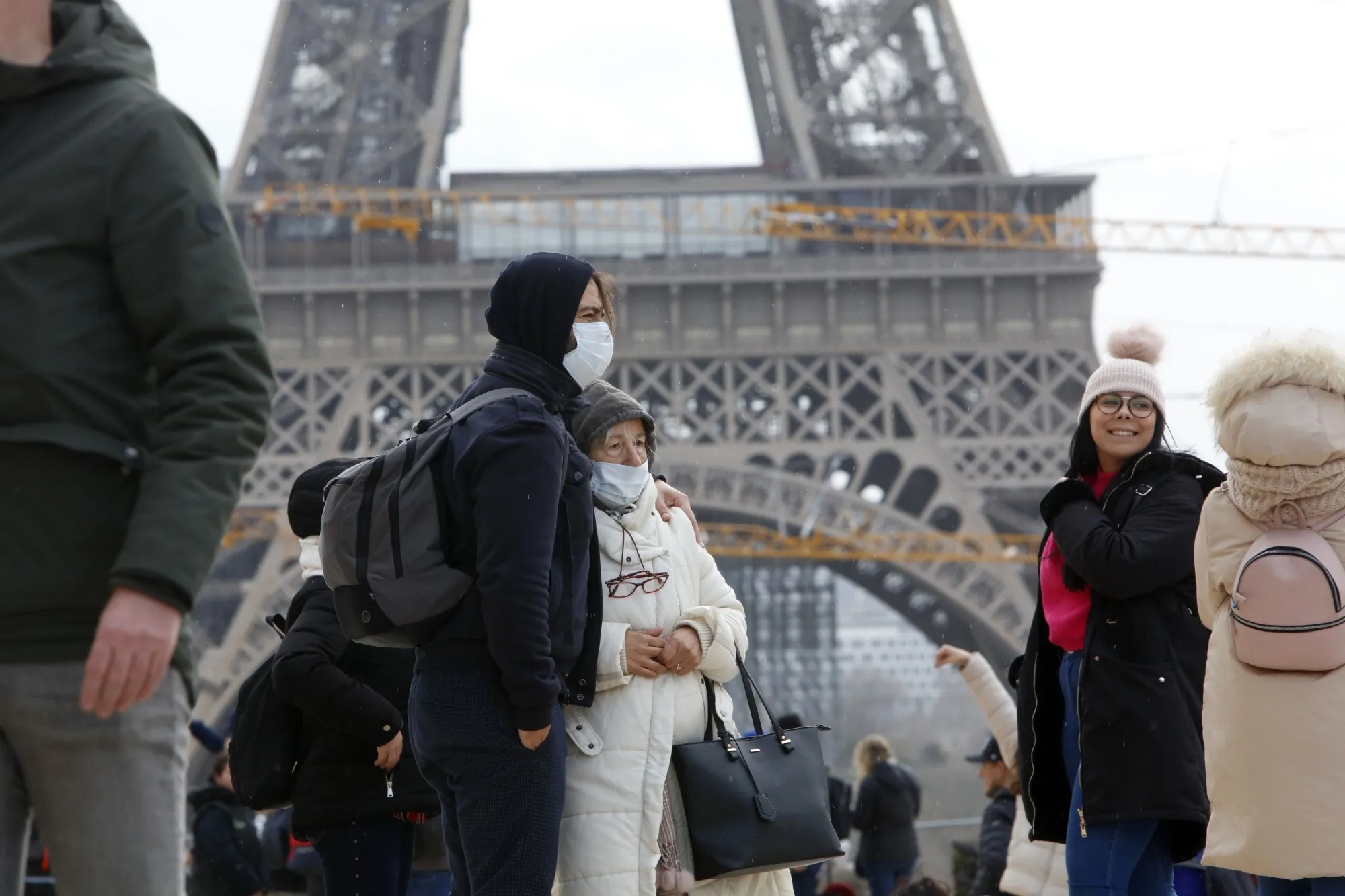 People wear face masks&nbsp;in front of the Eiffel Tower in Paris, on Feb.&nbsp;29.