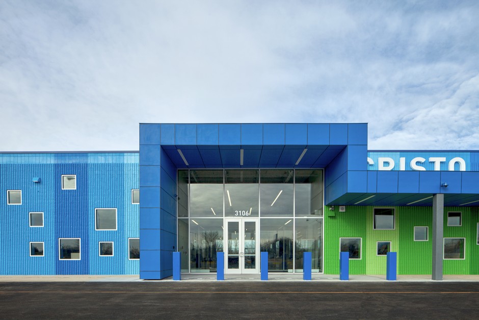 With a tight budget, the architects used glass and paint to transform the store into a well-lit, colorful high school. 