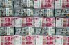 Genuine bundles of Chinese one-hundred yuan banknotes and U.S. one-hundred dollar banknotes are arranged for a photograph at the Counterfeit Notes Response Center of KEB Hana Bank in Seoul, South Korea, on Friday, July 13, 2017. Yuan is set to slide for fifth week, longest losing streak since July 2016, as escalating U.S.-China trade tensions weigh on sentiment.