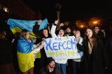 People hold a banner that says "Kherson is Ukraine"