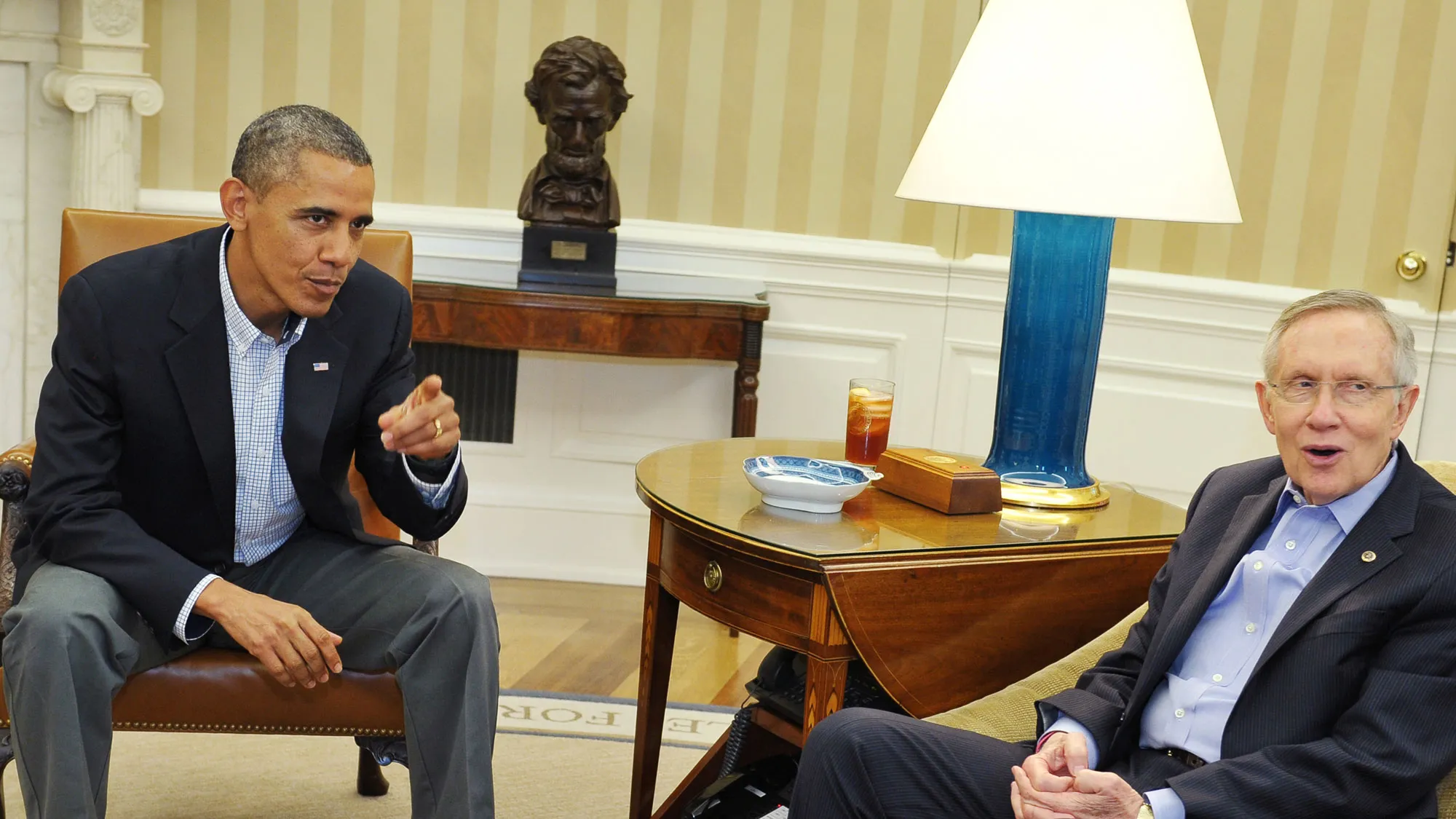 US President Barack Obama (L) sits next to Senate Majority Leader Harry Reid, D-NV, during a meeting with Senate Democratic leadership in the Oval Office of the White House on October 11, 2013 in Washington, DC.
