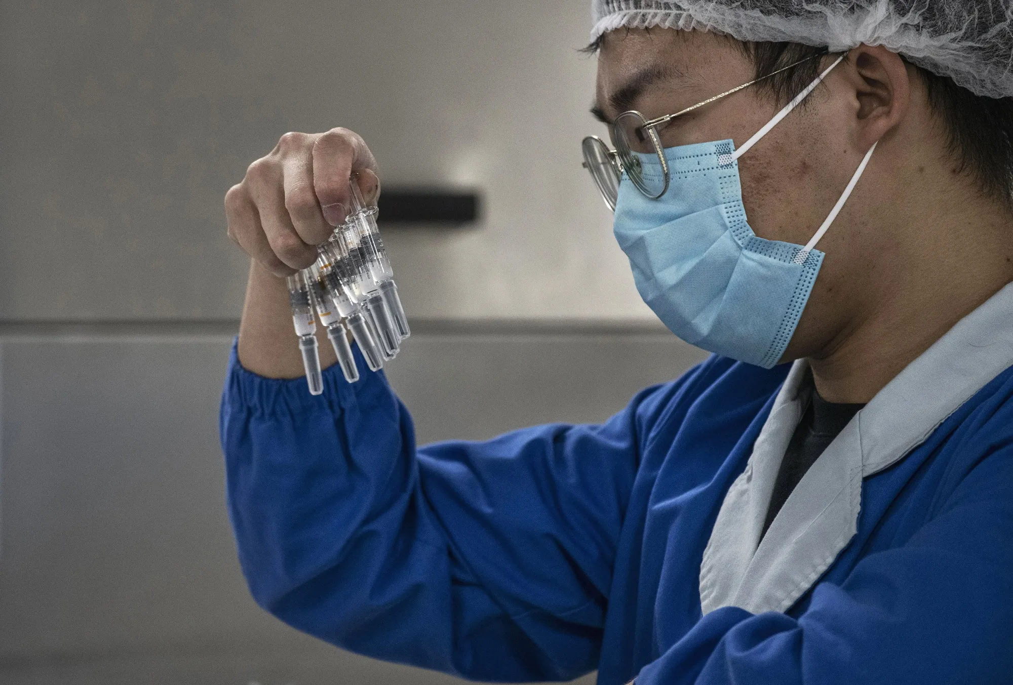 A lab technician checks Covid-19 vaccines in Beijing.