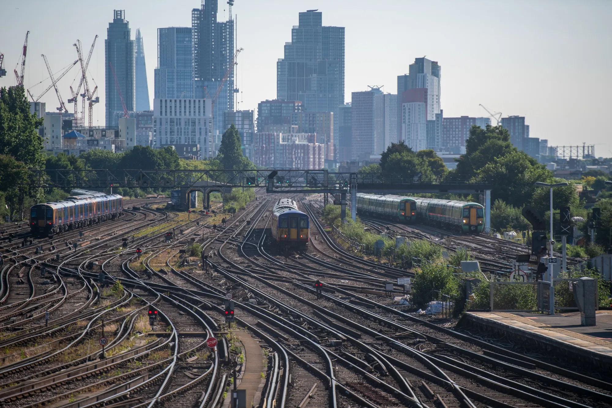 Passenger trains arrive at Clapham Junction railway station in London, UK.