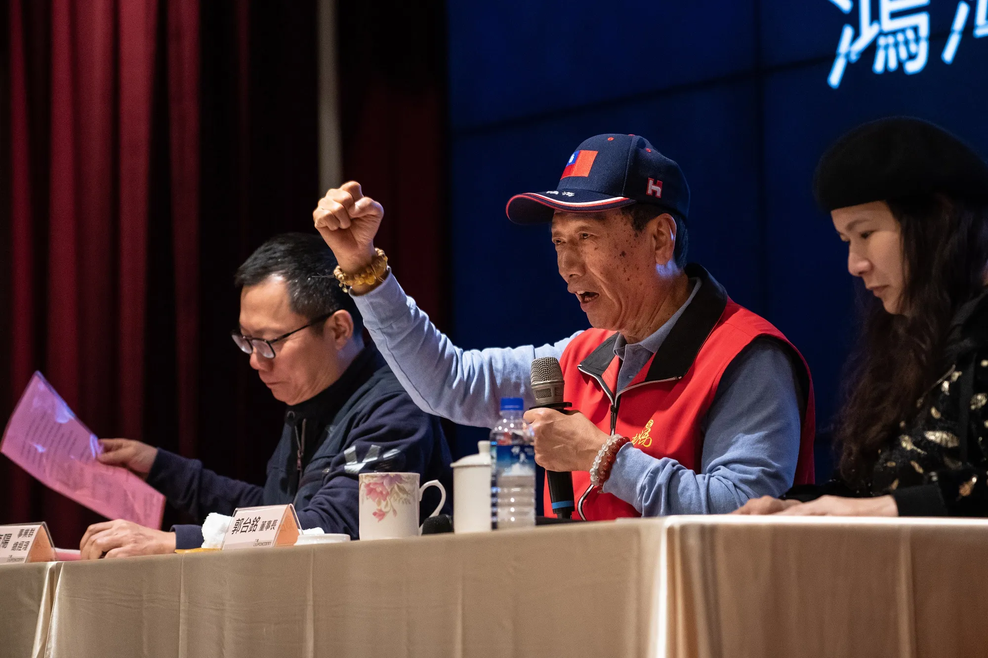 Terry Gou, chairman of Foxconn Technology Group, center, gestures while speaking as Calvin Chih, chief executive officer of FIH Mobile Ltd., a subsidiary of Foxconn, left, looks on during a news conference at Foxconn's headquarters in New Taipei, Taiwan, on Tuesday, March 12, 2019. Billionaire Gou responded with outrage to a low-key Microsoft Corp. patent lawsuit, accusing the software giant of a personal attack against him and his company.