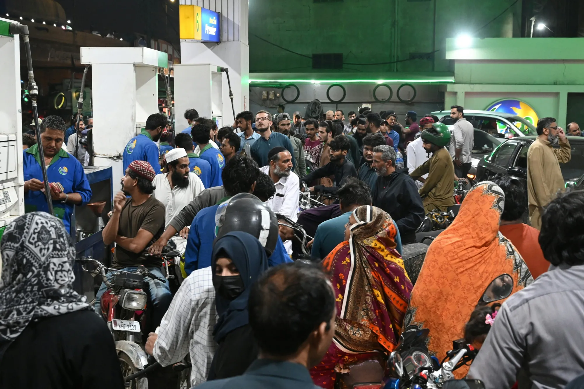 Customers queue at a gas in Karachi on March 7.