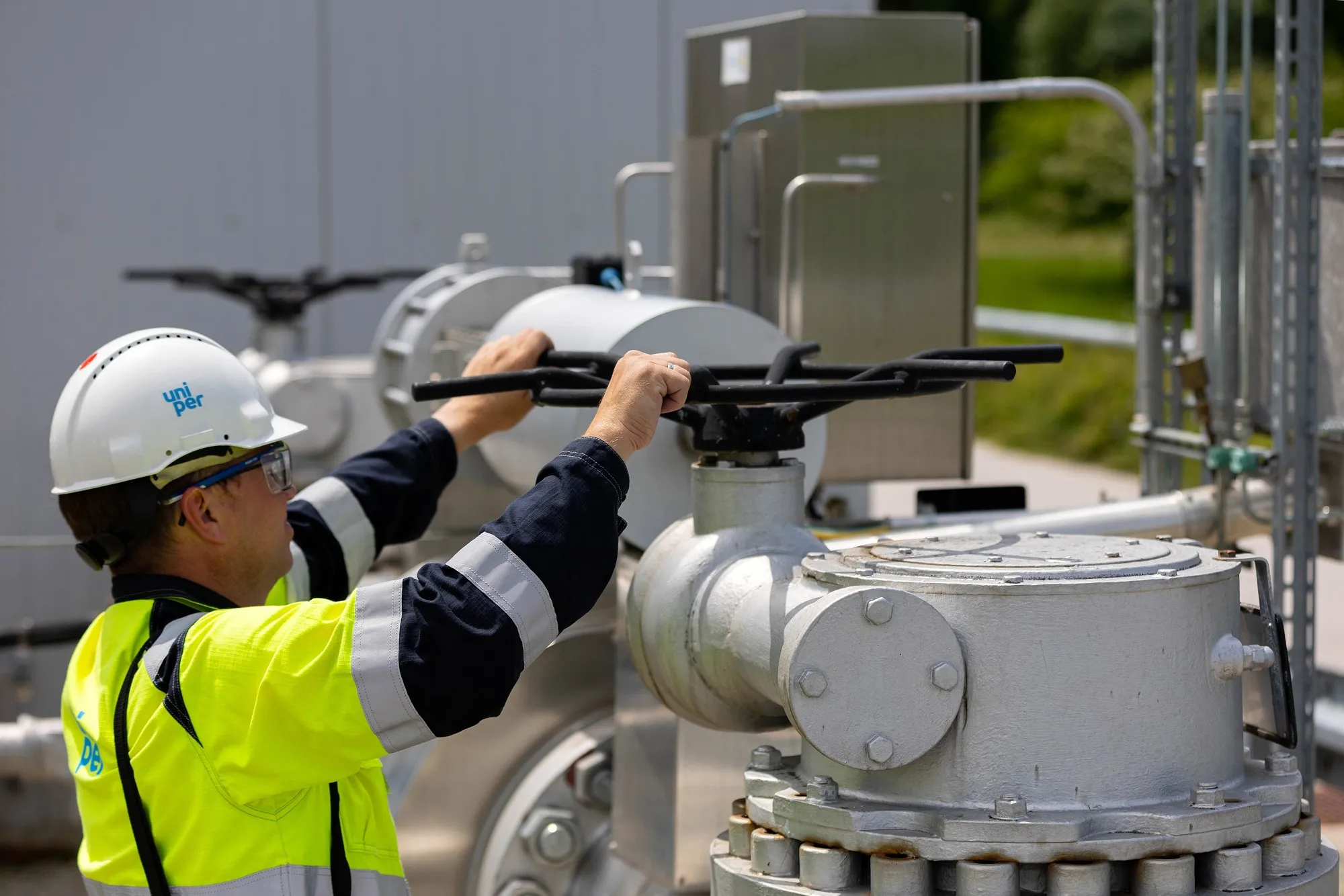 An employee adjusts a control valve at a natural gas facility in Muhldorf, Germany.