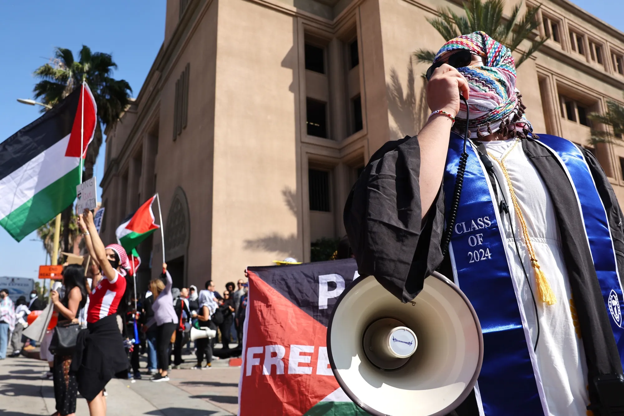 Pro-Palestinian protestors demonstrate at an entrance to Pomona College's commencement ceremony at Shrine Auditorium on May 12, 2024 in Los Angeles, California.