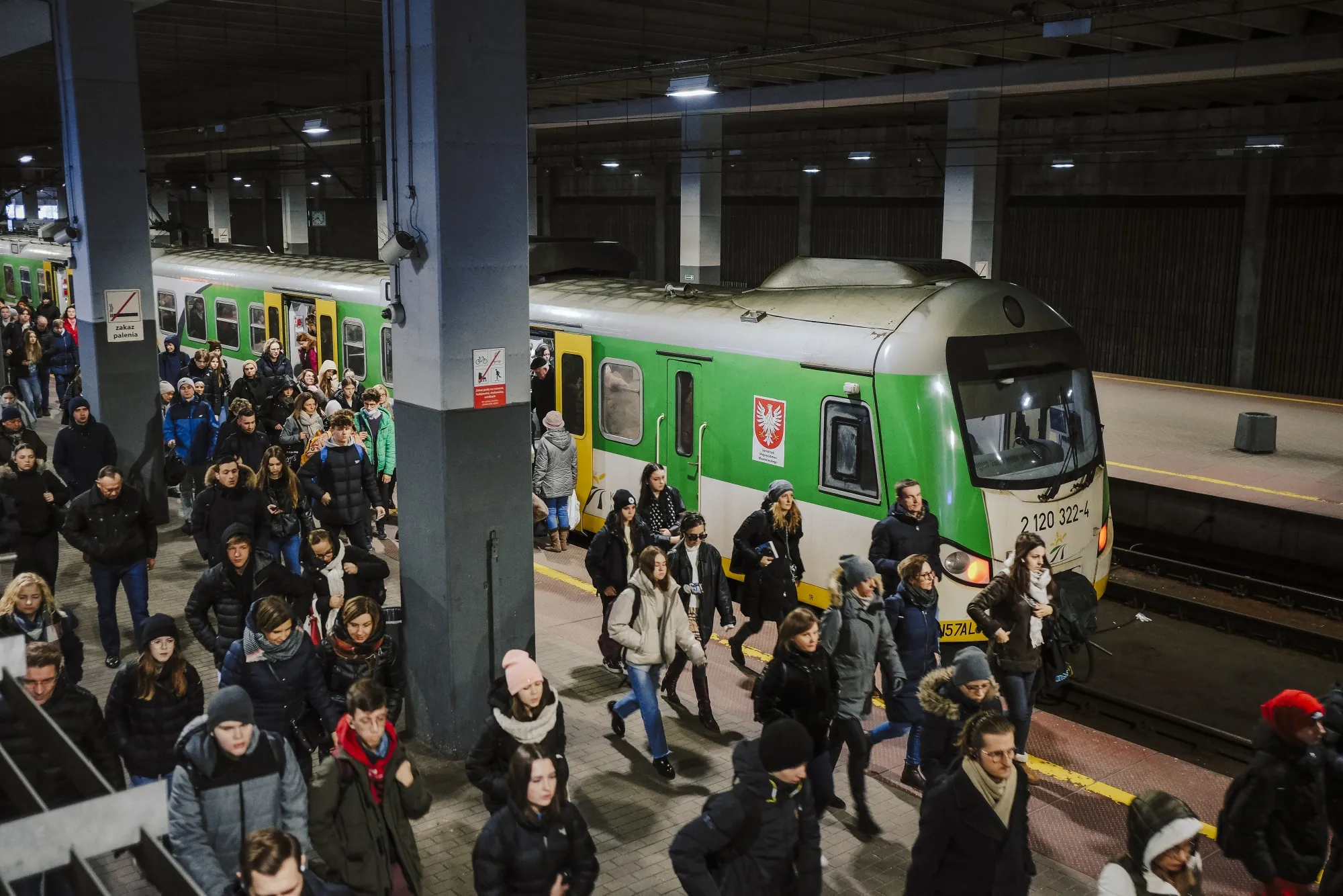 Commuters at a train station in Warsaw.