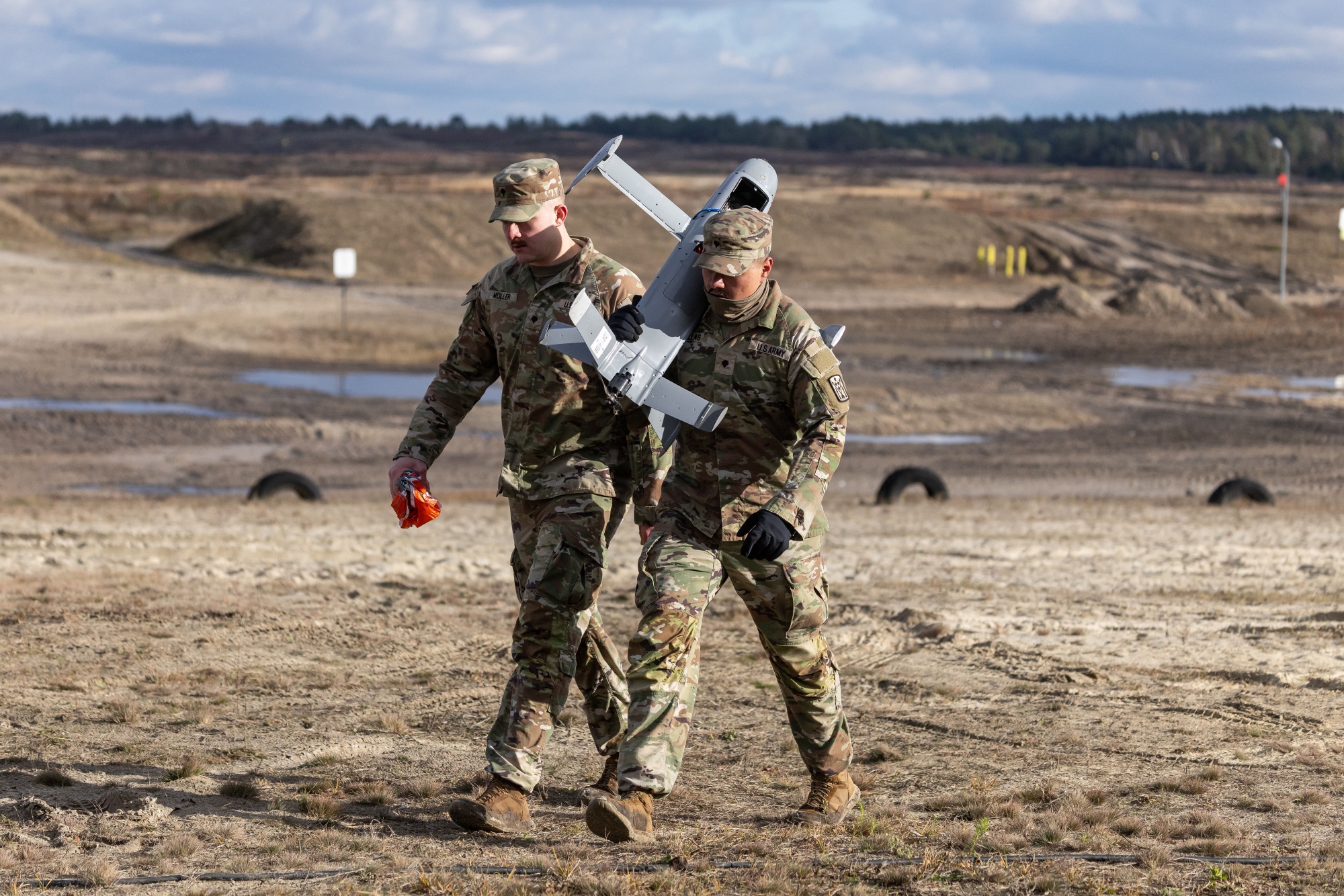 US soldiers carry an interception drone of the American Merops counter drone system during tests at the Nowa Deba military training ground in south-eastern Poland, on Nov. 18, 2025.