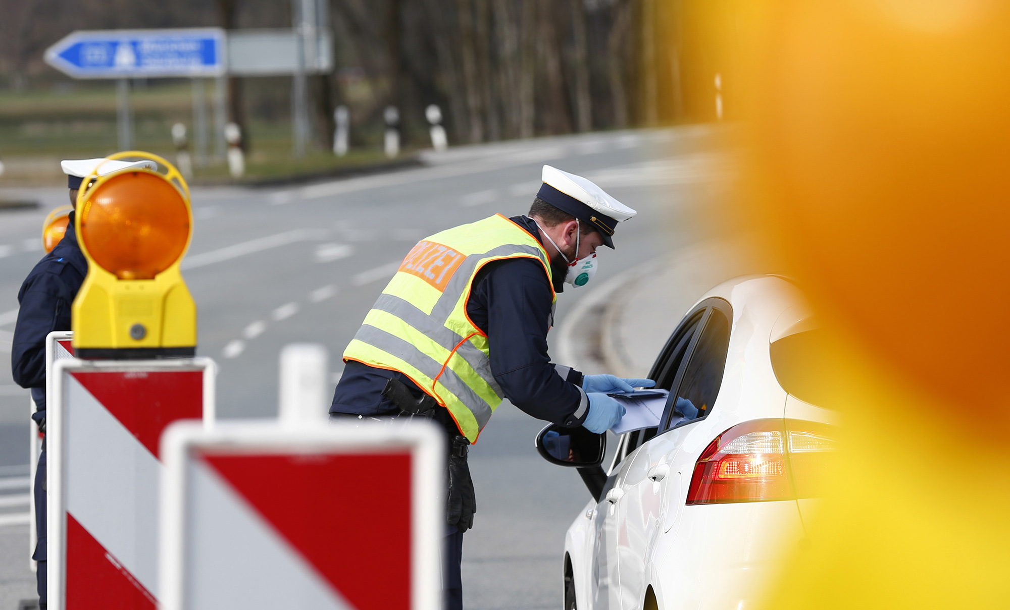 A police officer checks a driver's paper work on Austria’s border with Germany&nbsp;in Ebbs, Austria, on&nbsp;March 17.&nbsp;