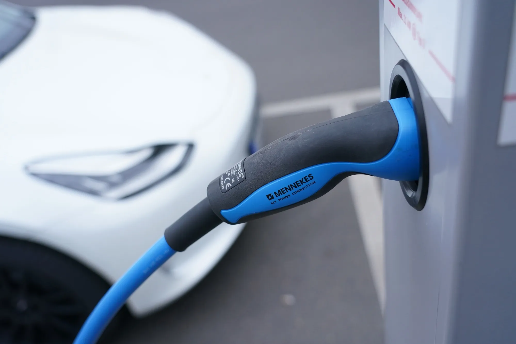A Tesla electric vehicle charges at a public charging station in December.