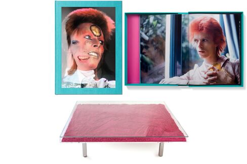 Pictured: An early '70s shot of David Bowie by photographer Mick Rock (top); Yves Klein’s transparent pigment coffee table (bottom).