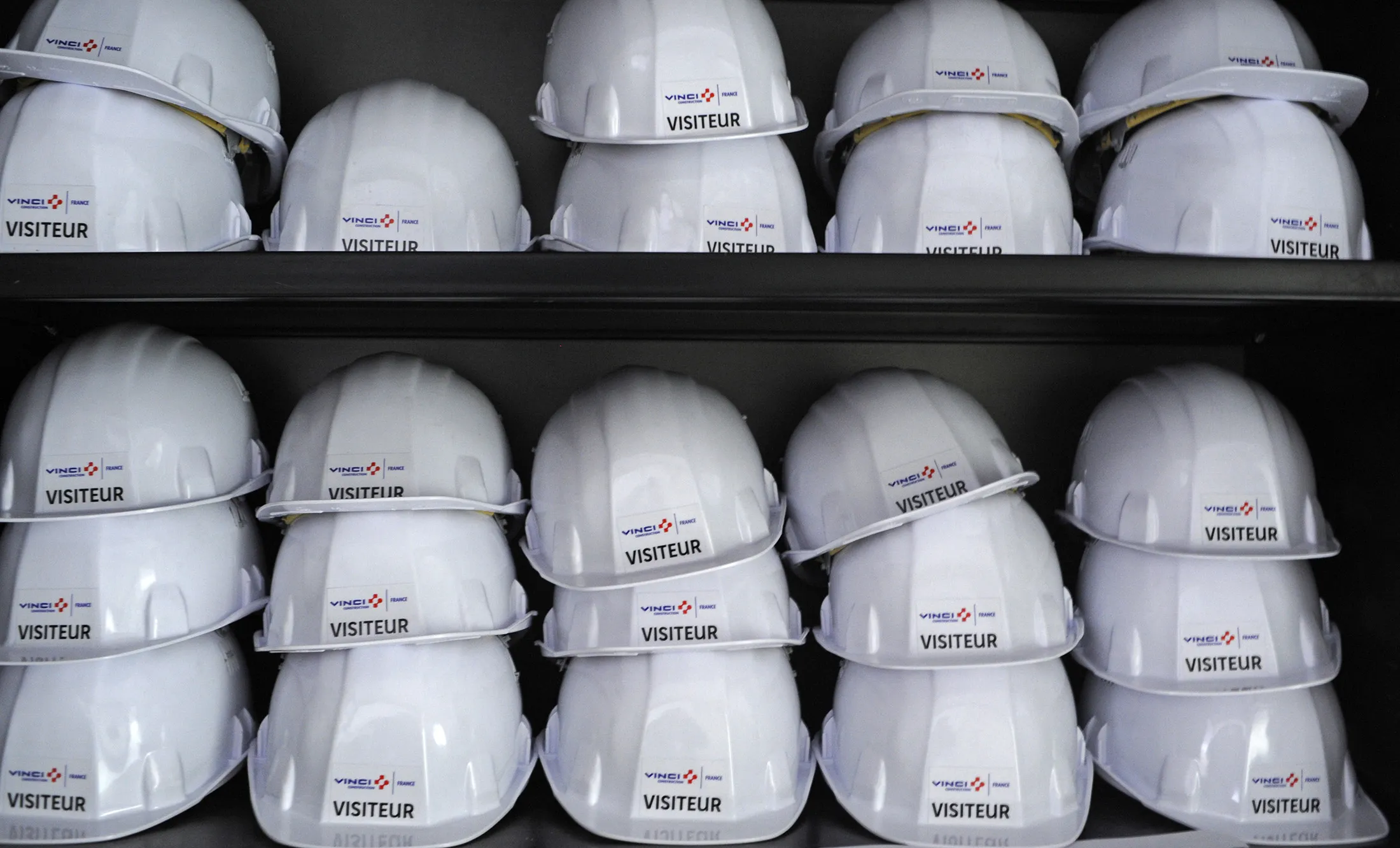 Vinci hard hats are seen on a shelf at a Vinci SA construction site.
