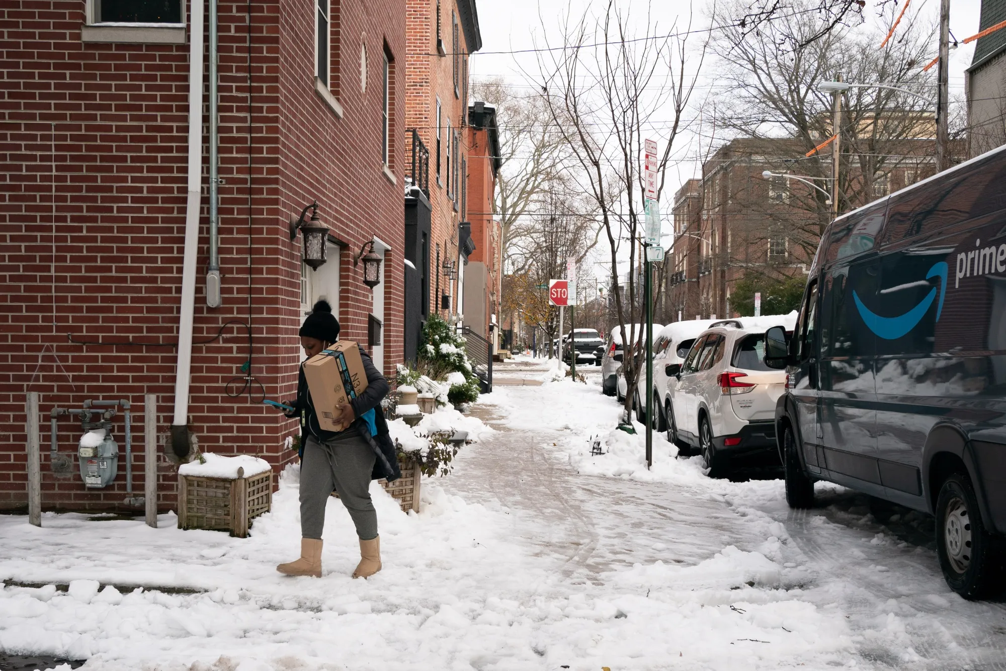 An Amazon delivery driver carries a package in Philadelphia, Pennsylvania.